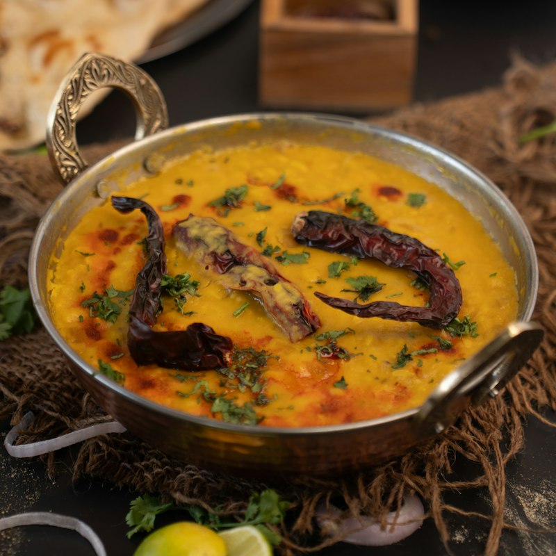 A karahi of daal chana, thick and golden, finished with a tarka of dried red chilli and fresh coriander